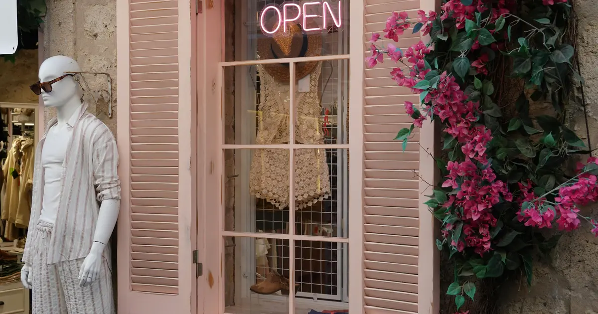 Independent retail store front, open sign visible in window